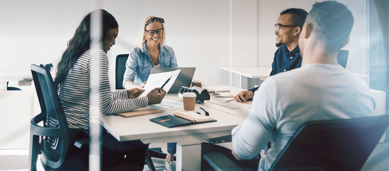 a team discussing analytics around a table